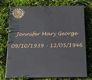 Simple slate tablet with engraved lettering in gold.