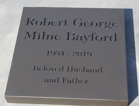 Slate memorial deep engraved with black letters.