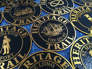 Circular bronze signs for a heritage trail.