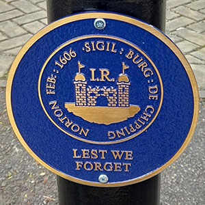 Bronze commemorative plaque with a blue background.