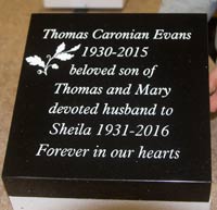 Black granite wedge with carved white lettering Black granite wedge with carved white lettering