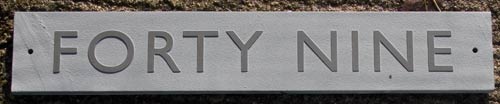 Raised and unpainted slate house sign