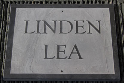 Slate house sign with raised letters and a border