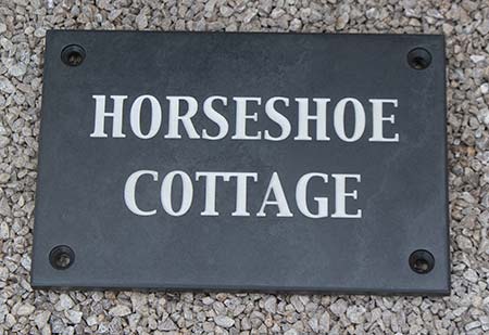 Slate house sign with countersunk holes drilled.