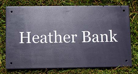 Simple Welsh slate house sign.