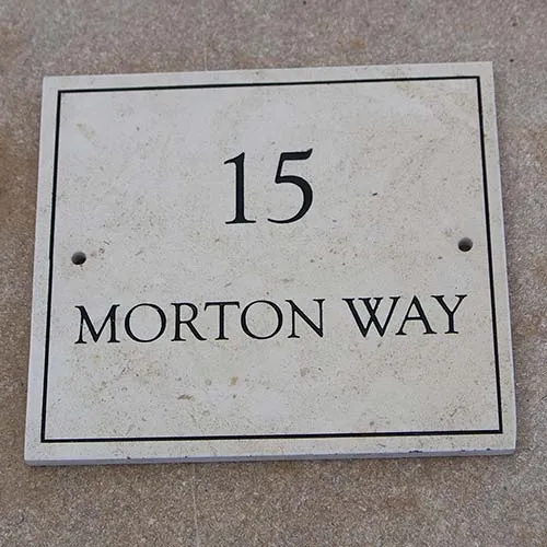 This sign has a painted line border Limestone Address Sign