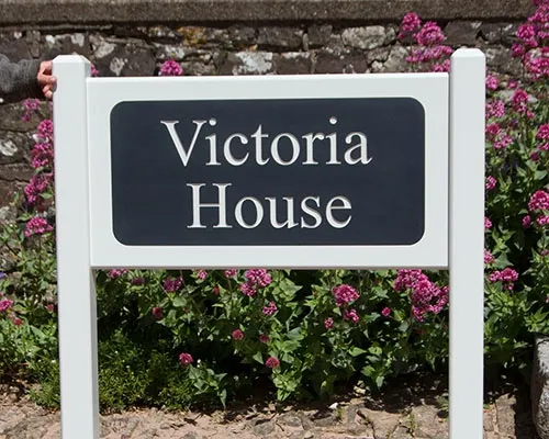 Made with engraved corian inlaid in sold hardwood Painted Hardwood Entrance Sign.