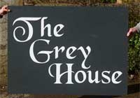 Large dark grey composite sign boards.