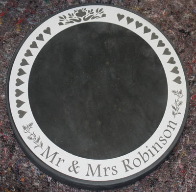 Large round slate which can be used as a cake stand or as decoration in the centre of the table.
