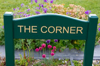 Painted wooden sign morticed into posts. Painted wooden sign morticed into posts.