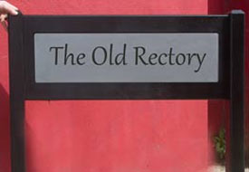 Engraved corian plaques inlaid into oak sign Engraved corian plaques inlaid into oak sign