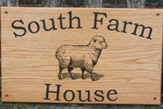 Wooden farm sign with image of a sheep.