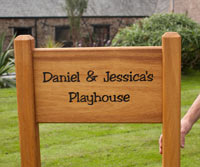 Wooden sign morticed into posts. Wooden sign morticed into posts.