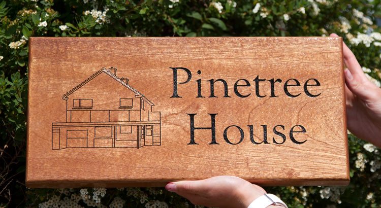 Wooden house sign treated with CoachKote.