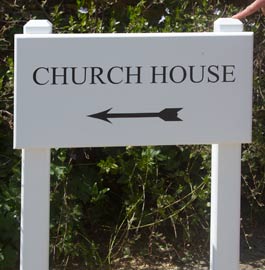 White painted oak sign on white painted oak posts